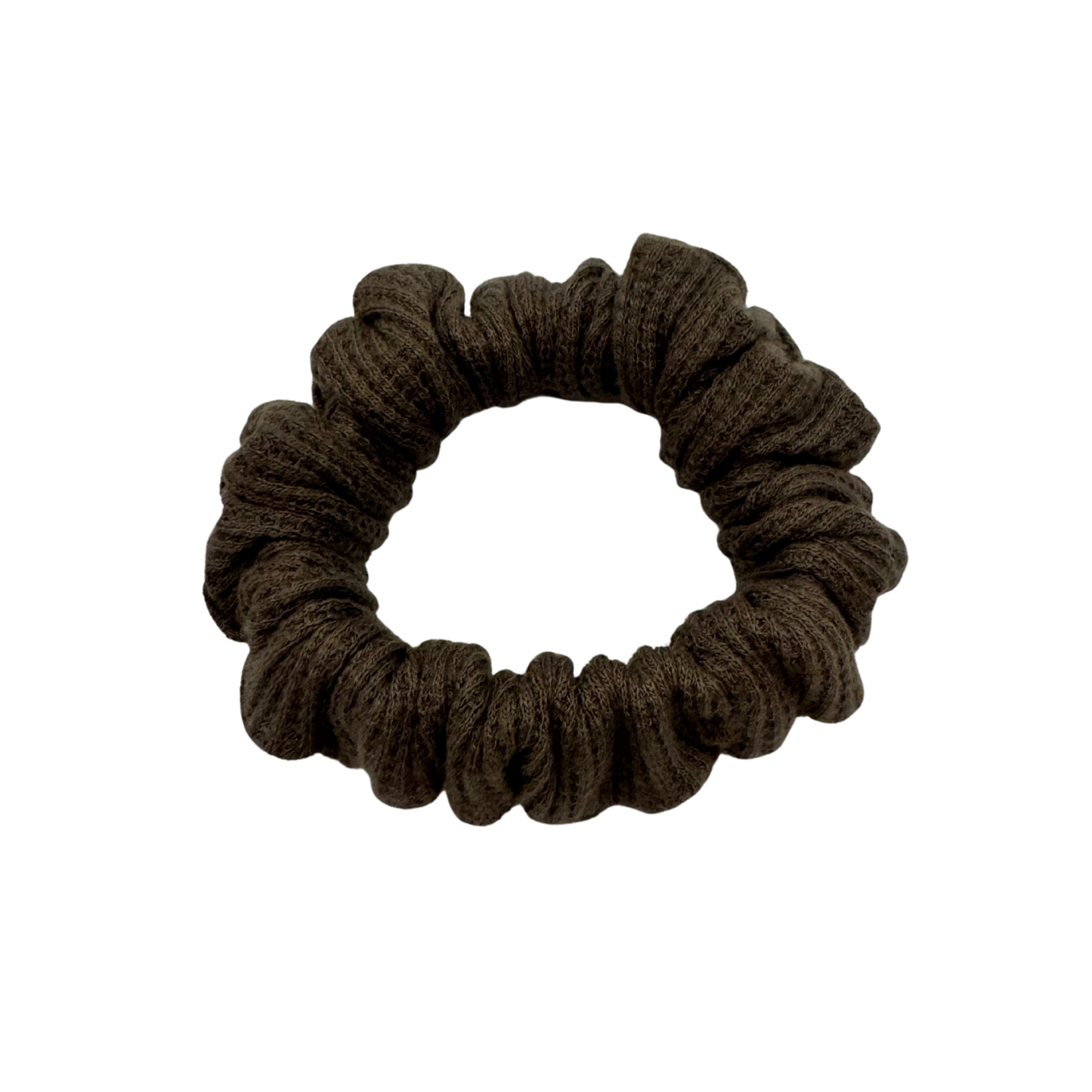 One brown waffle-knit cotton scrunchies.  The textured fabric features a soft, ribbed pattern, offering a cozy and voluminous look. Ideal for gentle hair styling across different hair types and preferences