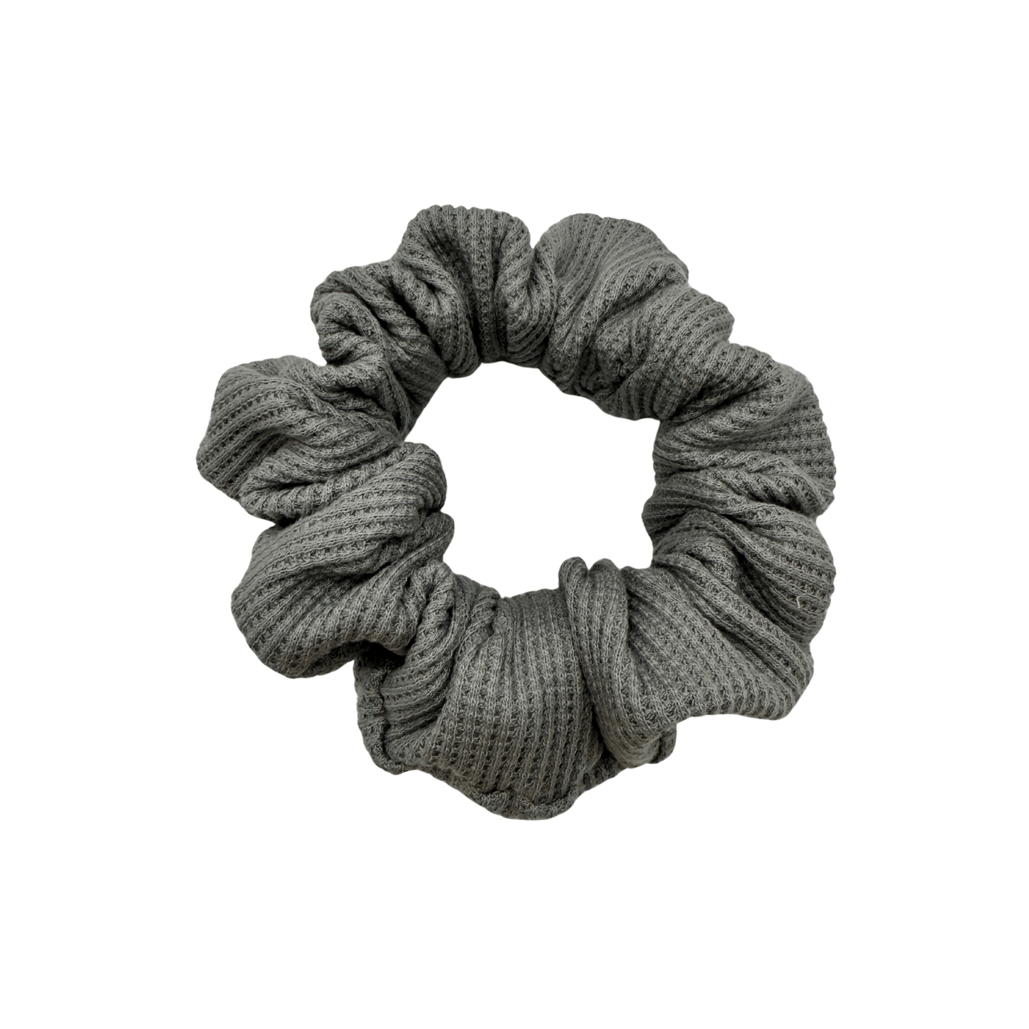 One grey waffle knit cotton scrunchie on a white background. Perfect for thick to medium hair, this scrunchie adds a touch of cozy soft elegance to any look.