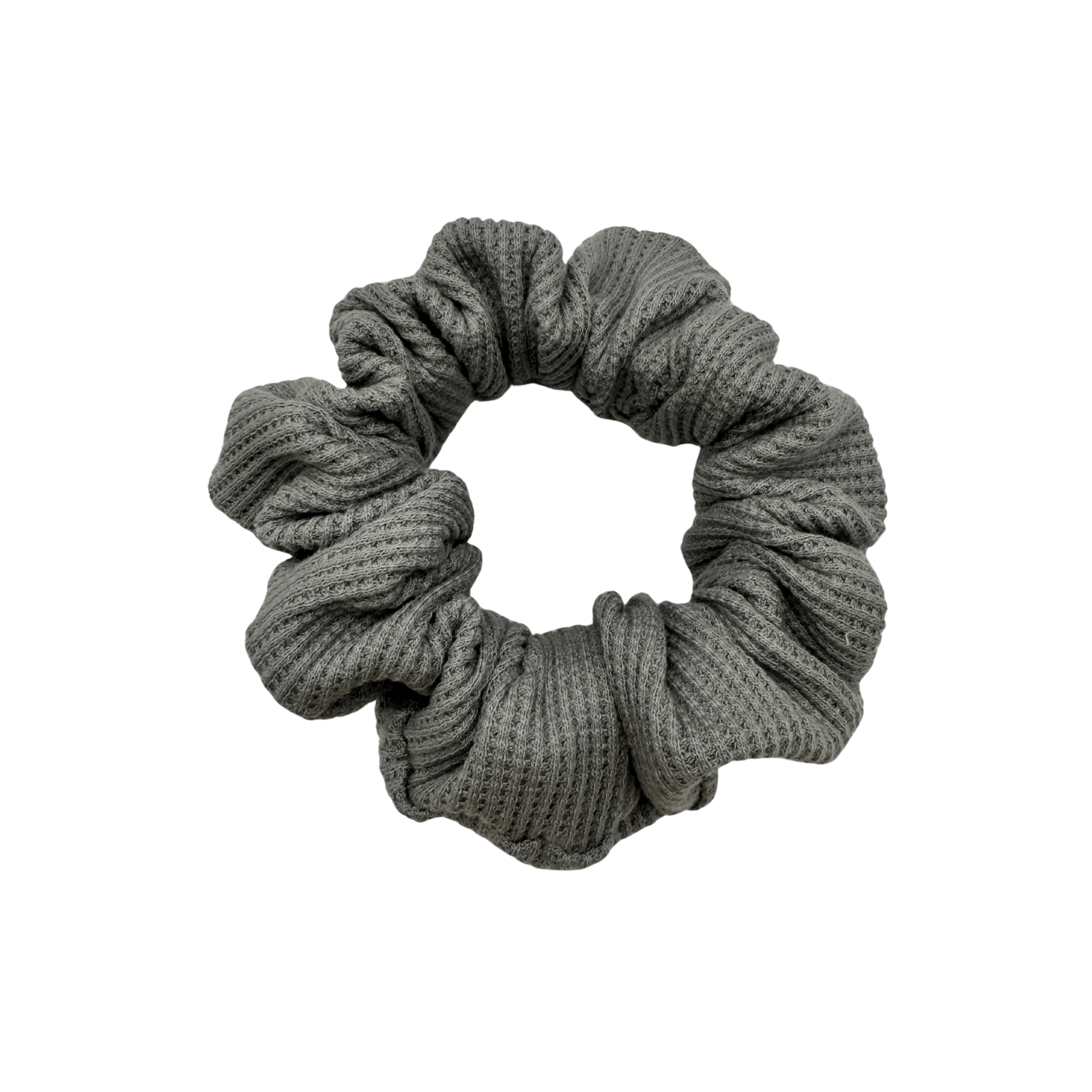 One grey waffle knit cotton scrunchie on a white background. Perfect for thick to medium hair, this scrunchie adds a touch of cozy soft elegance to any look.