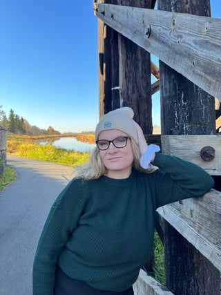 picture of owner smiling by a bridge with long blonde hair