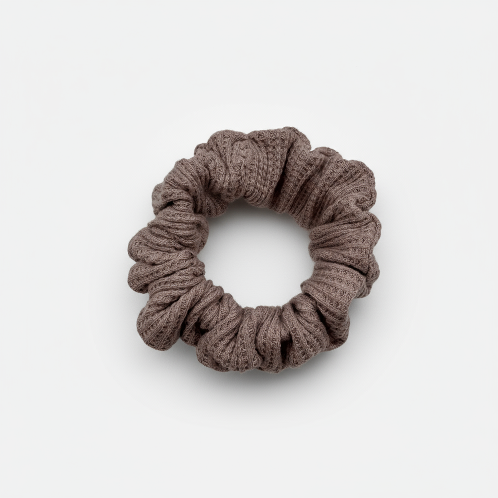 One Waffle Knit cotton scrunchie in muted mauve, styled in a circular shape with soft, gathered folds. Handmade and gentle on hair—ideal for cozy, everyday wear.
