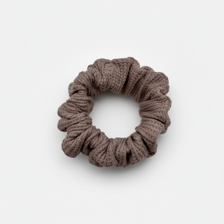 One Waffle Knit cotton scrunchie in muted mauve, styled in a circular shape with soft, gathered folds. Handmade and gentle on hair—ideal for cozy, everyday wear.