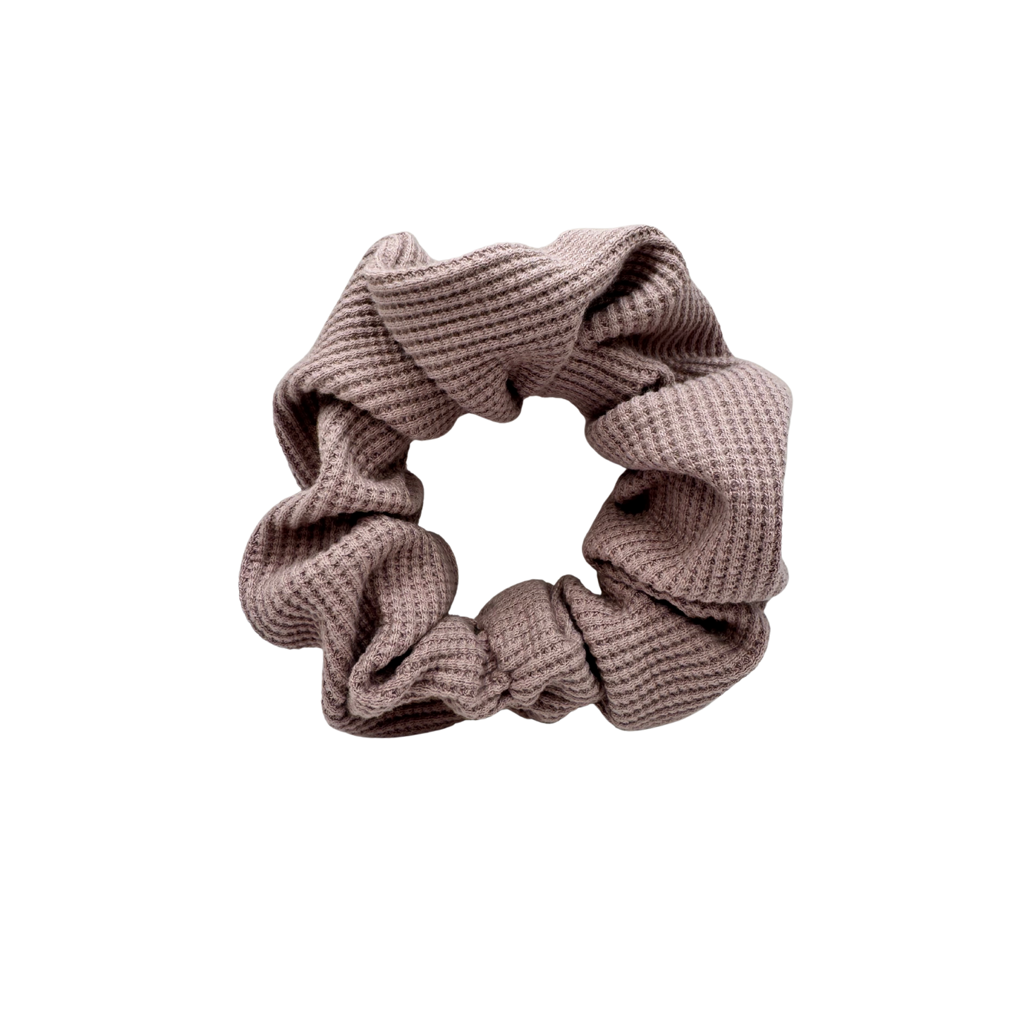 One Waffle Knit cotton scrunchie in muted mauve, styled in a circular shape with soft, gathered folds. Handmade and gentle on hair—ideal for cozy, everyday wear.