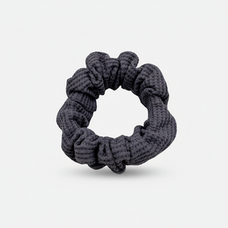 Plush waffle-knit cotton scrunchie in a rich purple hue, gathered into soft folds for visual charm and gentle volume. Handmade for a secure, damage-free hold and effortlessly graceful everyday styling.