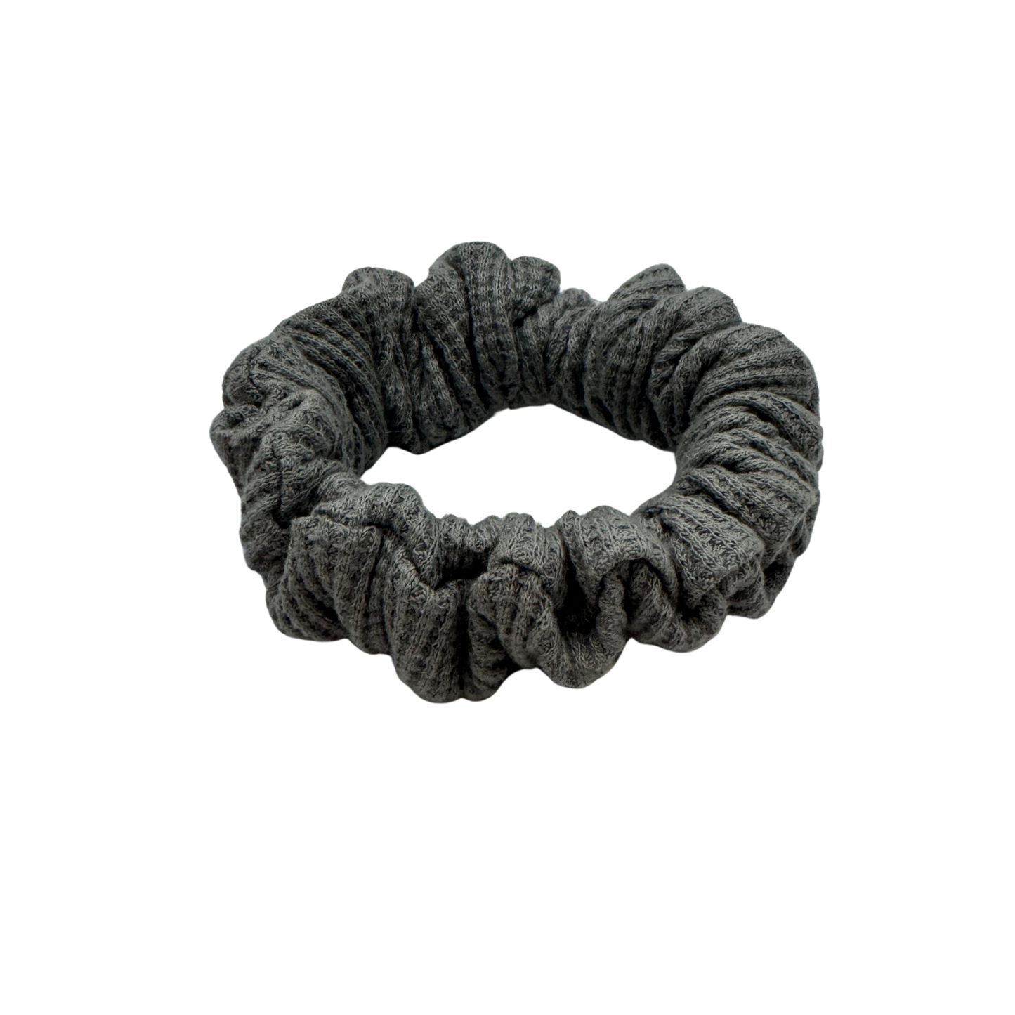 One grey waffle knit cotton scrunchie on a white background. Perfect for thick to medium hair, this scrunchie adds a touch of cozy soft elegance to any look.