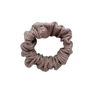 One Waffle Knit cotton scrunchie in muted mauve, styled in a circular shape with soft, gathered folds. Handmade and gentle on hair—ideal for cozy, everyday wear.