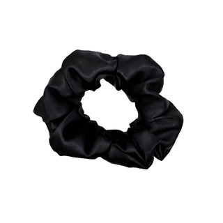 Black satin scrunchie with a smooth, glossy finish, gathered into soft ruffled folds. Handmade hair accessory designed for a gentle, secure hold and a sleek, timeless look.