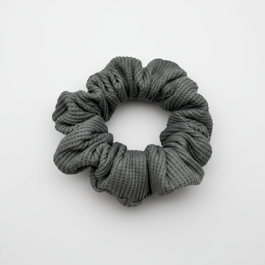 One Grey waffle knit cotton scrunchie on a white background. Perfect for thick to medium hair, this scrunchie adds a touch of cozy soft elegance to any look.
