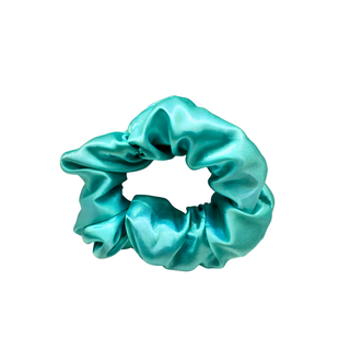 Ocean-blue satin scrunchie with a smooth, glossy finish and softly gathered folds. Handmade hair accessory designed for a gentle, secure hold and a serene, coastal-inspired look.
