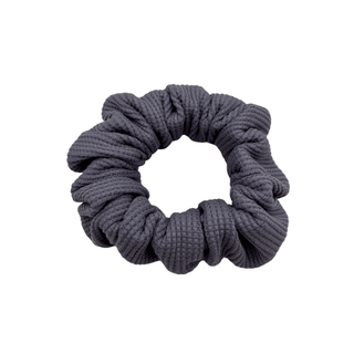 Plush waffle-knit cotton scrunchie in a rich purple hue, gathered into soft folds for visual charm and gentle volume. Handmade for a secure, damage-free hold and effortlessly graceful everyday styling.