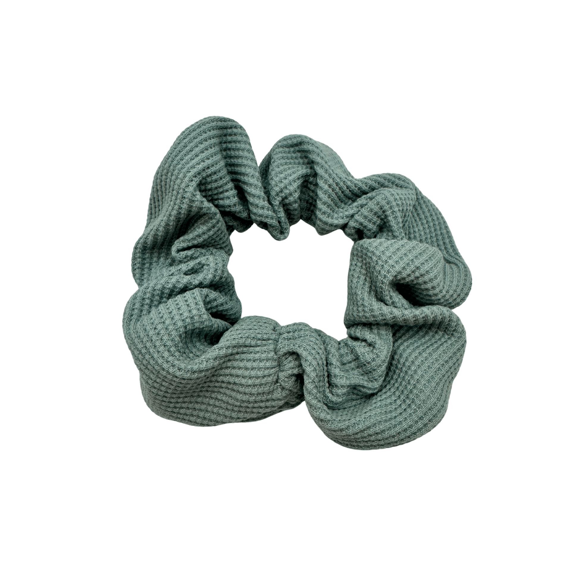 Textured sage green waffle knit scrunchie with visual soft volume, offering a gentle, secure hold for various hair types and styling preferences. 