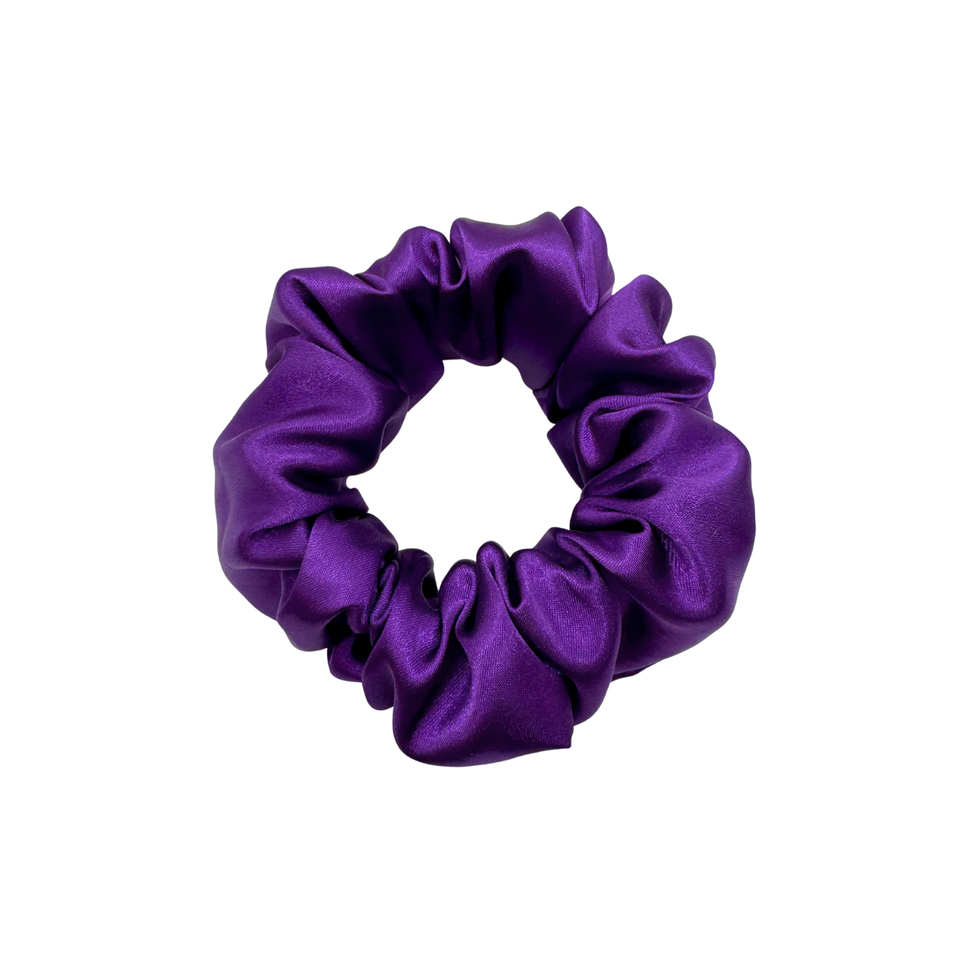 Medium-purple satin scrunchie with a soft, glossy finish and gently gathered ruffles. Handmade hair accessory designed for a secure, gentle hold and a romantic, celestial-inspired look.