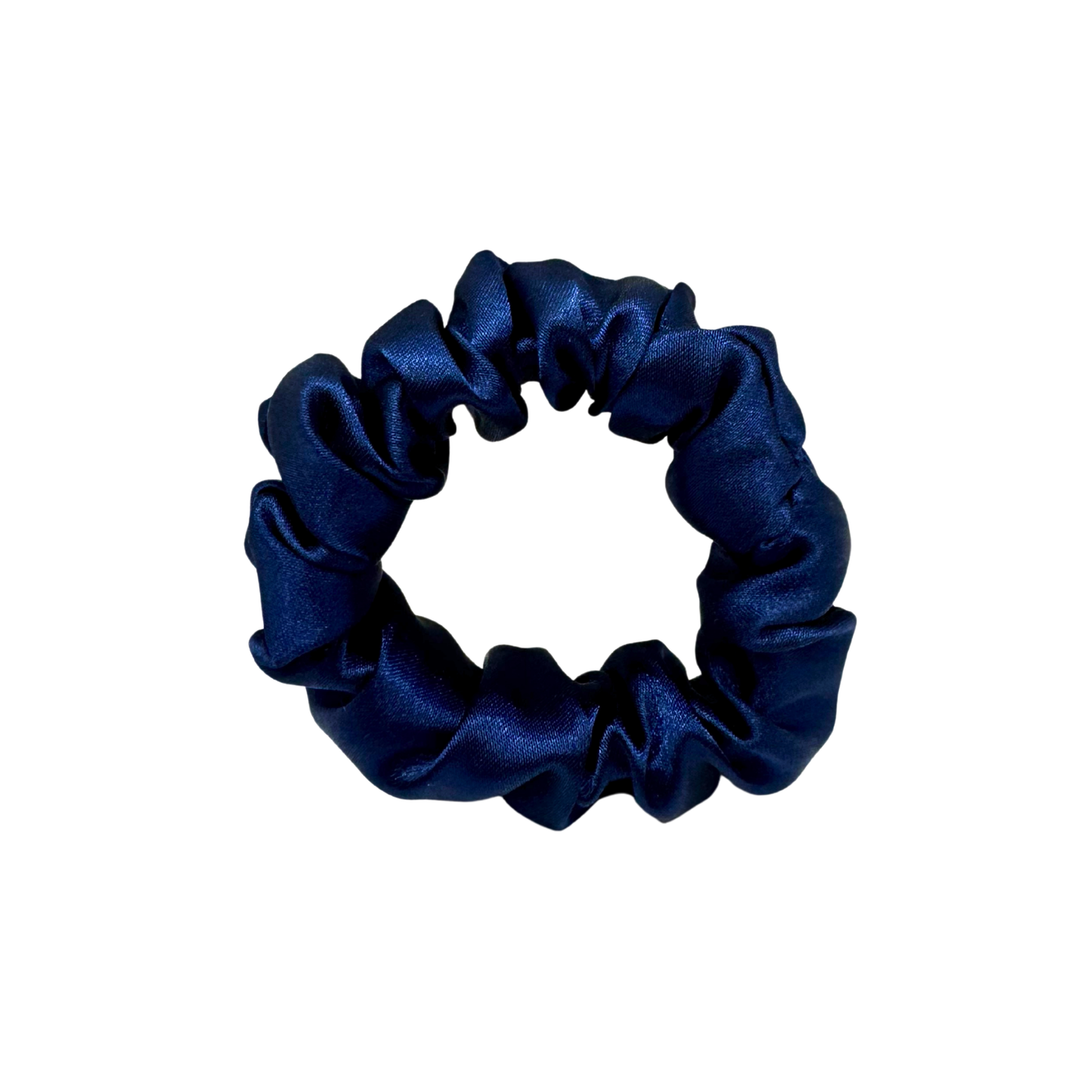 Deep navy satin scrunchie with a soft, luminous sheen and gently gathered folds. Handmade in Canada for a secure, damage-free hold and elegant everyday styling.