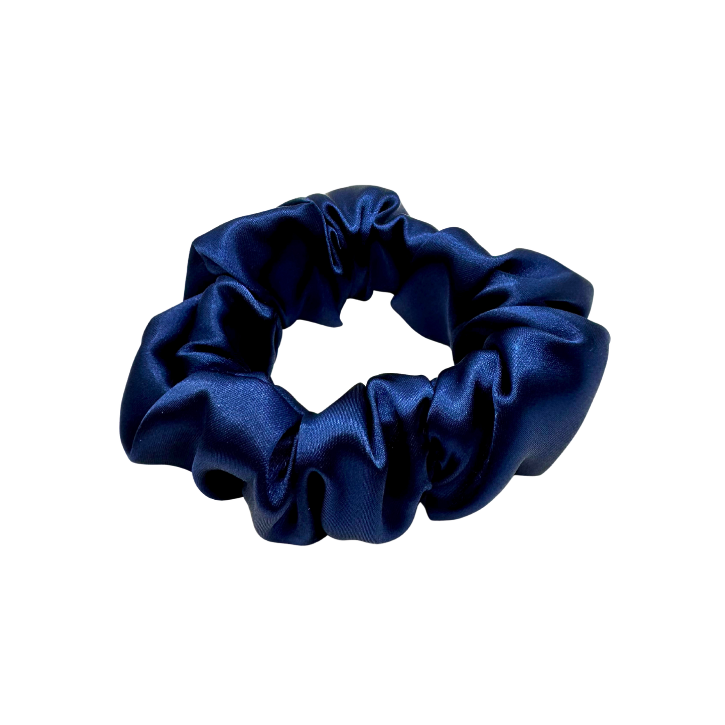 Deep navy satin scrunchie with a soft, luminous sheen and gently gathered folds. Handmade in Canada for a secure, damage-free hold and elegant everyday styling.