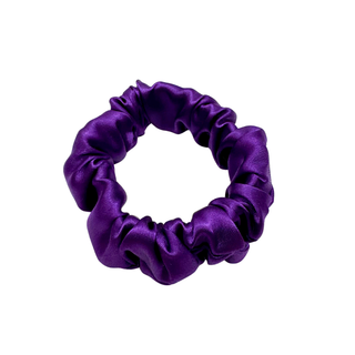 Medium-purple satin scrunchie with a soft, glossy finish and gently gathered ruffles. Handmade hair accessory designed for a secure, gentle hold and a romantic, celestial-inspired look.