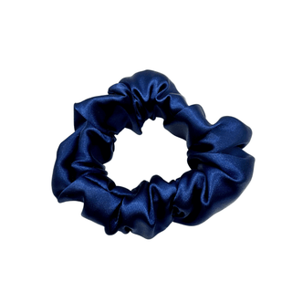 Deep navy satin scrunchie with a soft, luminous sheen and gently gathered folds. Handmade in Canada for a secure, damage-free hold and elegant everyday styling.